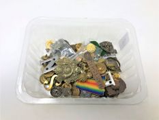 A collection of military buttons and cap badges etc
