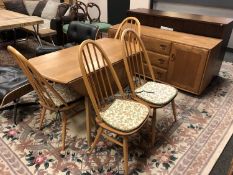 An Ercol Golden Dawn six piece dining room suite : long low sideboard, width 156 cm,