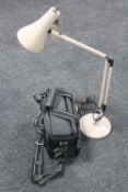 An angle poise desk lamp, together with a camera bag containing brass mantel clock,