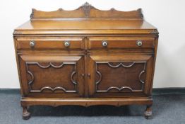 An Edwardian oak double door sideboard