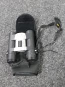 A pair of cased Nikon sport lite 10x 25 binoculars