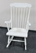 A painted spindle back rocking chair