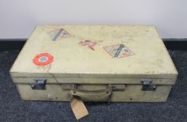 A pig skin luggage case bearing shipping labels