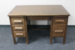 A 1930's oak twin pedestal desk