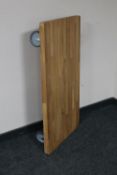 A contemporary oak topped low table on industrial castors