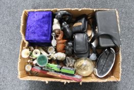 A box of clock radio, camera, goblets, clock under shade,