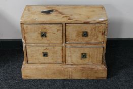 An antique pine miniature four drawer chest