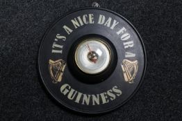A circular Short & Mason barometer mounted on board bearing Guinness advertising