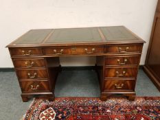 A reproduction mahogany double pedestal desk retailed by Chapmans,