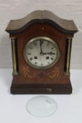 An Edwardian inlaid mahogany mantel clock with silvered dial and French movement