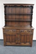 A carved oak double door Welsh dresser