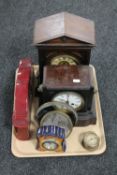 A tray of an Edwardian bracket clock with enamelled dial, an antique cast metal mantel clock,
