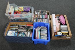 Four boxes of assorted DVD's and CD's together with a further box of children's dolls