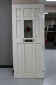 An early twentieth century painted front door with leaded glass panel