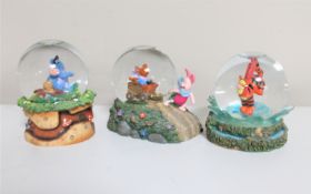 Three Disney snow globes : Winnie the Pooh and Friends
