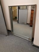 A contemporary silvered framed mirror