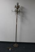 A decorative metal six way floor lamp with glass drops