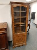 A glazed walnut display cabinet, width 60 cm.