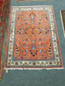 A Malayer rug, on salmon ground,