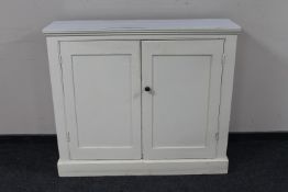 A painted antique pine double door cupboard