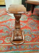 A carved mahogany plant stand in the form of a fish, height 68 cm.