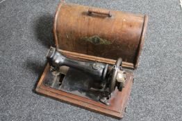 A cased vintage Singer hand sewing machine