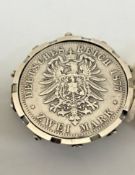 A silver Deutsches Reich Zwei Mark 1877 (C), mounted to a brooch.