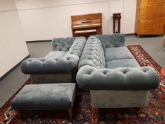 A three piece Delcor lounge suite comprising of three seater buttoned blue suede Chesterfield style
