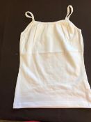 A box of seventy white cotton vests