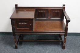 An oak linen fold telephone seat