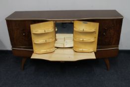 A mid twentieth century walnut Beautility cocktail sideboard