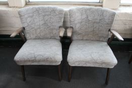 A pair of mid 20th century teak armchairs