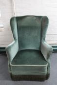 A mid 20th century wingback armchair