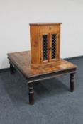A sheesham wood rectangular coffee table with metal mounts together with a double door corner