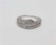 An 18ct white gold diamond set ring, set with brilliant and baguette-cut stones, size L.