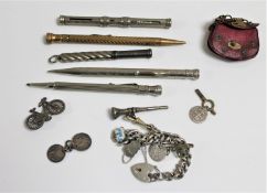 A box of silver mechanical pencils, charm bracelet,