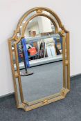 An ornate gilt framed wall mirror