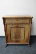 An antique mahogany cabinet fitted with a drawer on paw feet