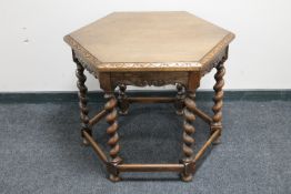 A hexagonal oak occasional table on barley twist legs