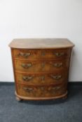 A 19th century continental mahogany and walnut bow fronted four drawer chest