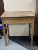 A teak clerk's desk on raised legs