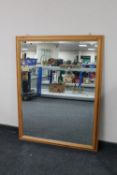 A pine framed bevelled overmantel mirror