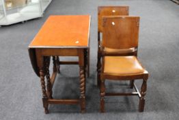 An oak gate leg table and two dining chairs