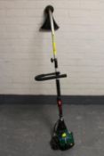 A Qualcast petrol garden strimmer