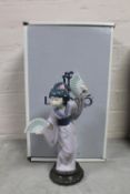 A Lladro figure of a Geisha holding fans