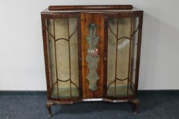 A 1920's walnut display cabinet
