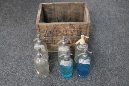 An antique wooden crate of six soda water siphons branded Zephyr and Schweppes