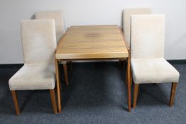 A vintage teak extending dining table and four later dining chairs