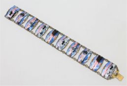 A Norwegian silver gilt and enamel panel bracelet, depicting winter and coastal landscapes,
