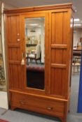 An Edwardian pine mirror door wardrobe